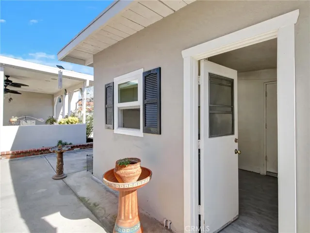 Outdoor laundry room leading to garage.