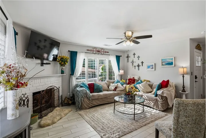 Living room near front door with great views from the large window. Lots of natural light from two windows. Nice roaring fireplace.