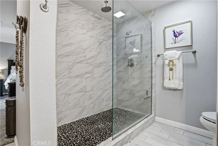 Walk-in tumbled shower and rainforest shower head