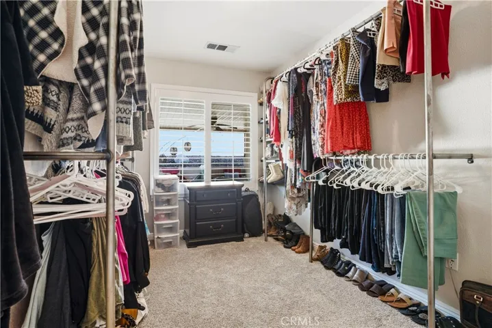 Extra large walk-in closet with a window for natural light