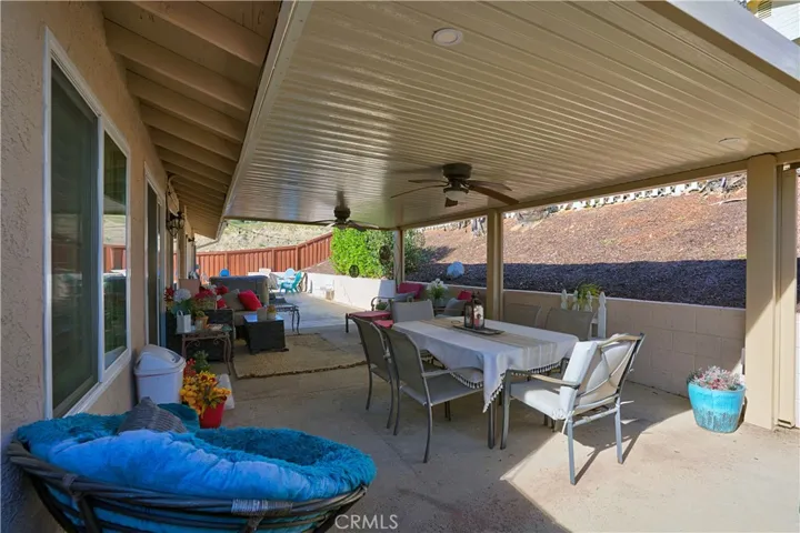 Outdoor covered aluminum patio with fans and electricity outlets.