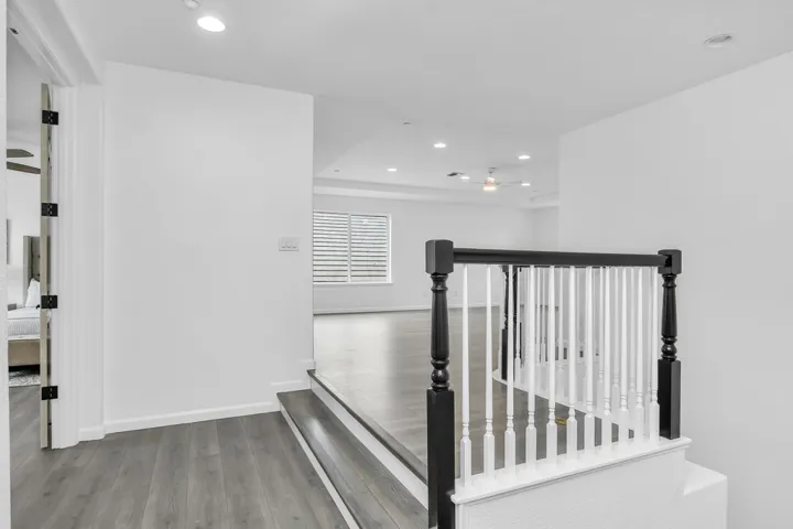 Corridor with light wood finished floors and recessed lighting