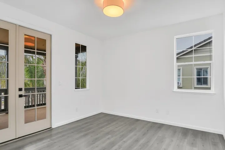 Spare room featuring light wood-style floors and french doors