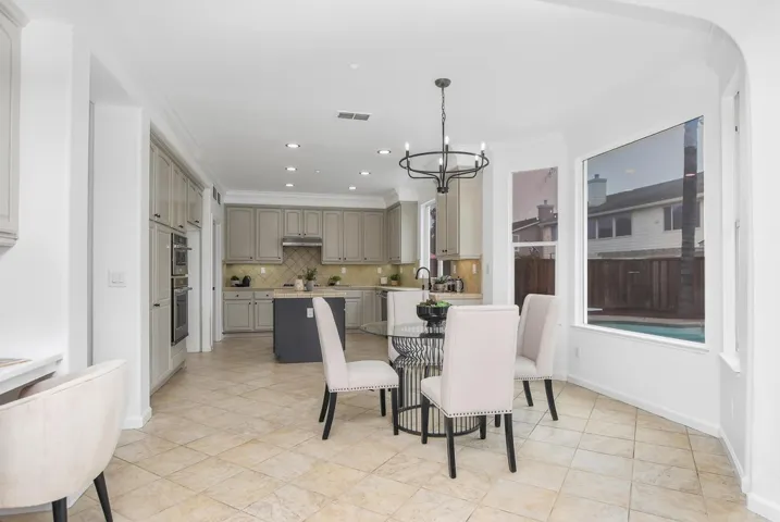 Dining space with a chandelier, crown molding, and recessed lighting