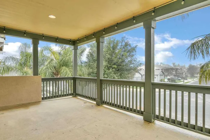 Unfurnished sunroom with rail lighting and concrete floors