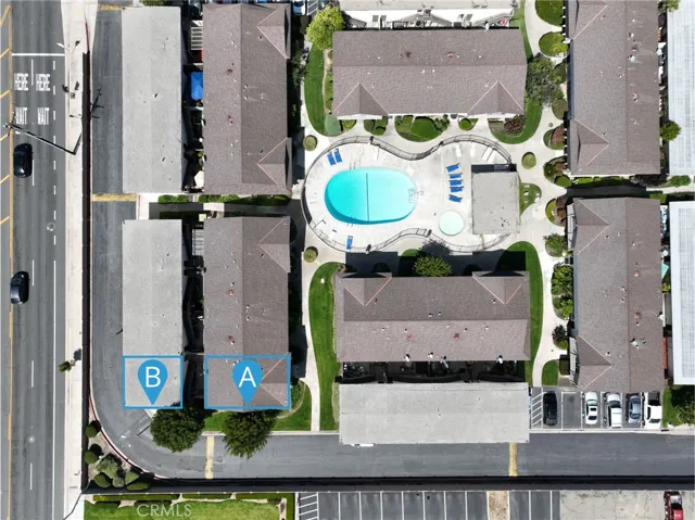 This top-down aerial view of the Fountain Valley townhome community highlights the location of 11115 Slater Ave #A within the complex. The image shows the unit’s position in Building A, along with nearby Building B, and the centrally located HOA pool, spa, and landscaped common areas.