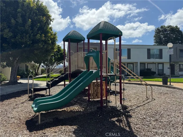 Community playground featuring slides, climbing structures, and open green space for outdoor recreation.