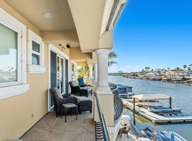 Balcony featuring a water view and a boat dock