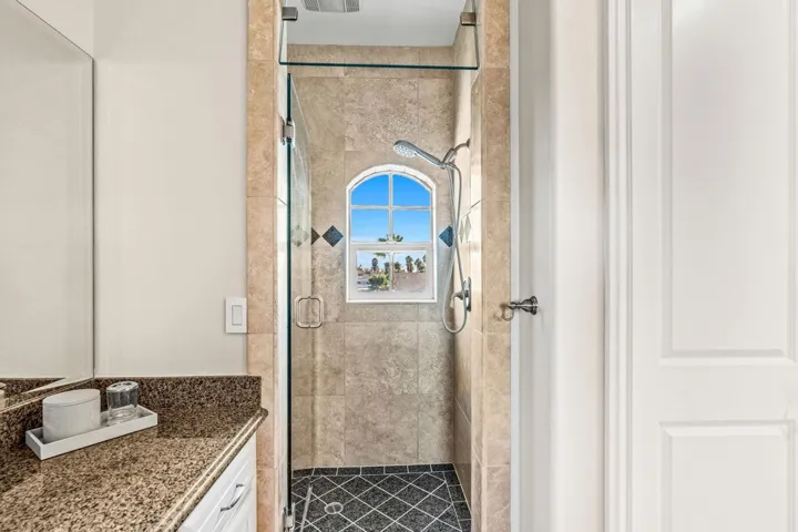 Bathroom featuring vanity and a shower stall
