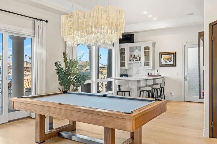 Playroom featuring ornamental molding, light wood-style floors, wet bar, billiards, and recessed lighting