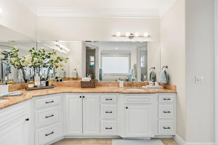 Bathroom with ornamental molding, double vanity, a stall shower, and light tile patterned flooring