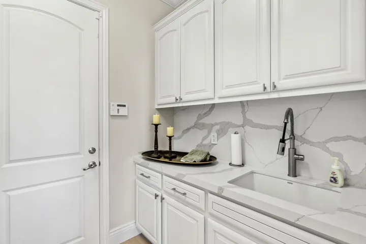 Washroom with a sink and baseboards