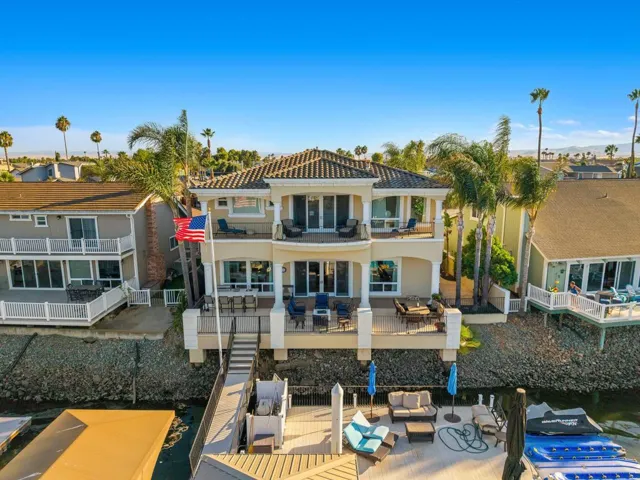 Rear view of house with outdoor lounge area, a balcony, stucco siding, a deck, and a residential view