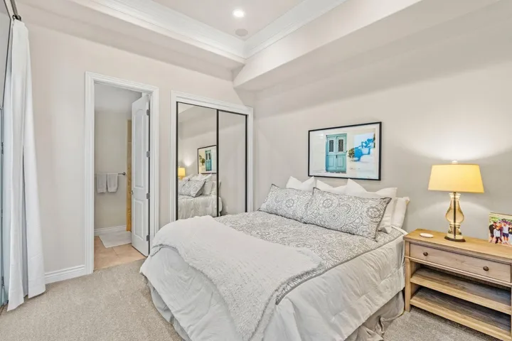 Bedroom featuring crown molding, light colored carpet, a closet, ensuite bathroom, and recessed lighting