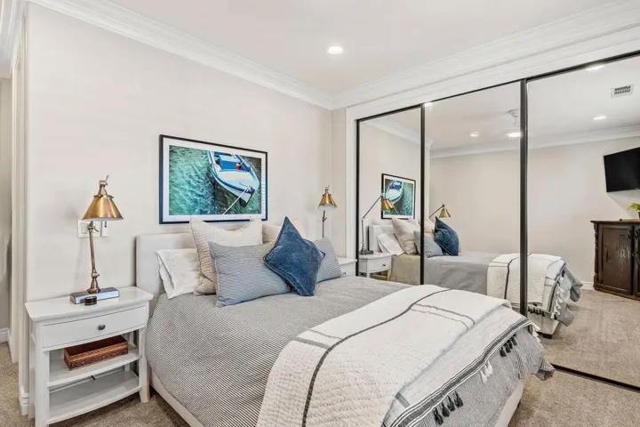 Bedroom with carpet flooring, ornamental molding, a closet, and recessed lighting