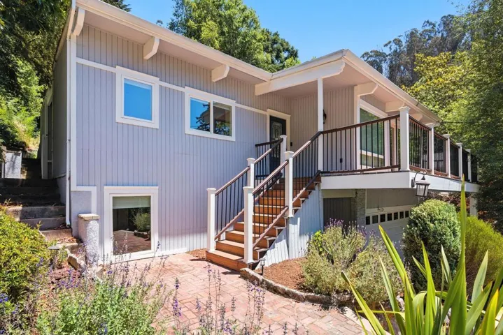 Rear view of house with a patio area, stairs, and a wooden deck