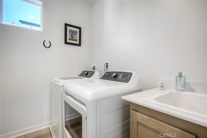 Laundry room w/utility room.