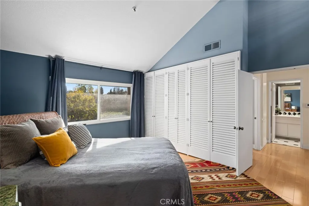 Primary suite with vaulted ceiling and golf course views and wall of closet space