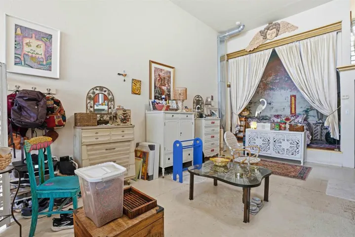 This unit features soaring high ceilings that enhance the open, light-filled feel of the space. Bright and spacious throughout, this unit offers room for a kitchen, refrigerator, full bathroom and a well designed layout that feels airy and comfortable!
