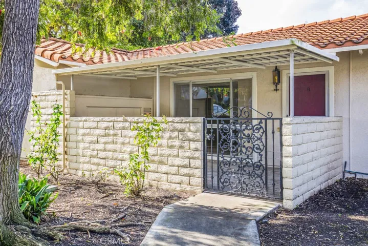 Entry to the residence. Covered front courtyard contains a large storage cabinet and is well-suited for year-round outdoor dining, entertaining and relaxing.
