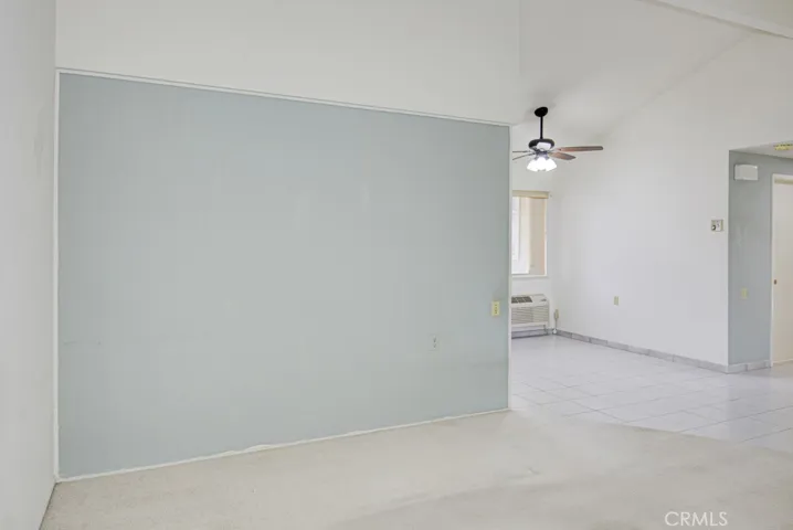 Another view of the living room. Dining area can be seen at right.