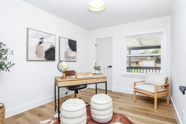 Office area featuring light wood-style floors and baseboards