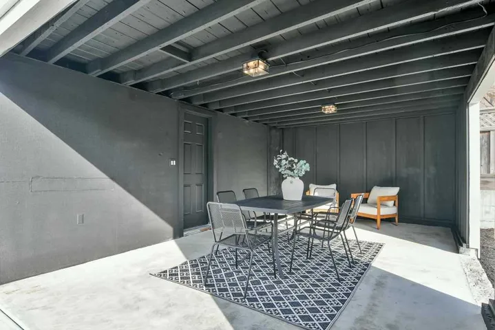 Dining area with concrete floors and beam ceiling