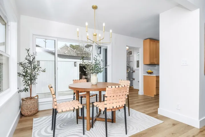 Dining room with light wood-style flooring and a chandelier