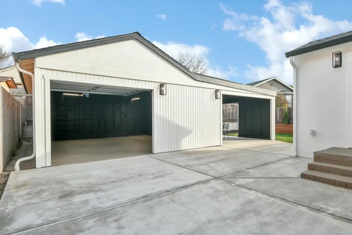 Garage featuring concrete driveway