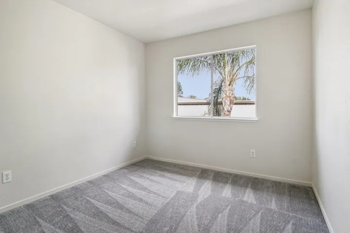 Spare room with carpet floors and baseboards