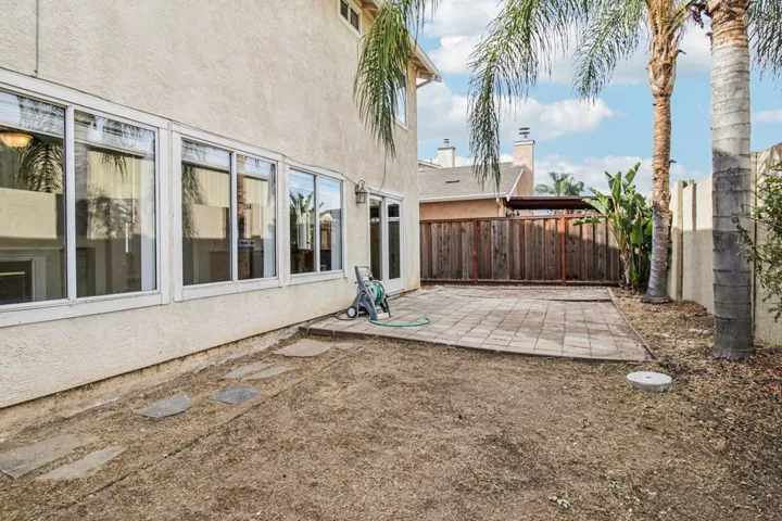 Fenced backyard with a patio area