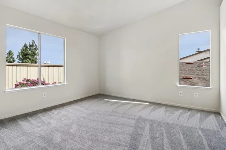 Unfurnished room featuring carpet and healthy amount of natural light