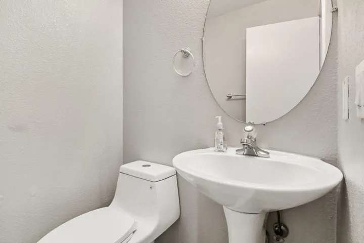 Half bathroom with a textured wall