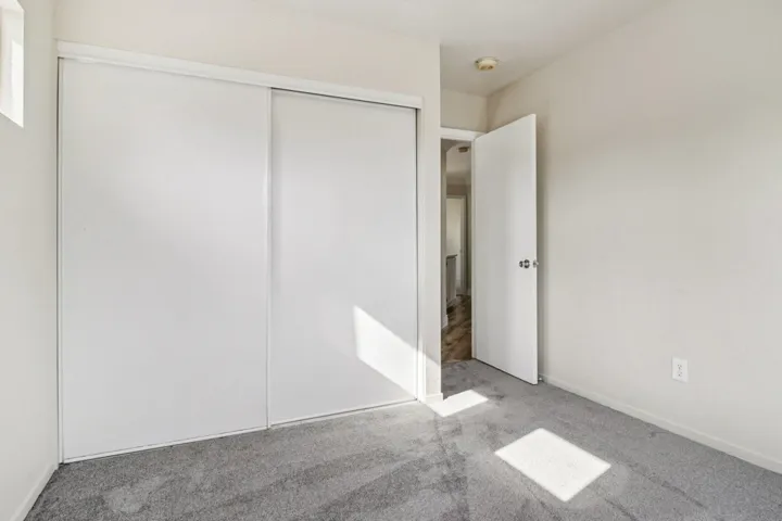 Unfurnished bedroom featuring carpet flooring and a closet