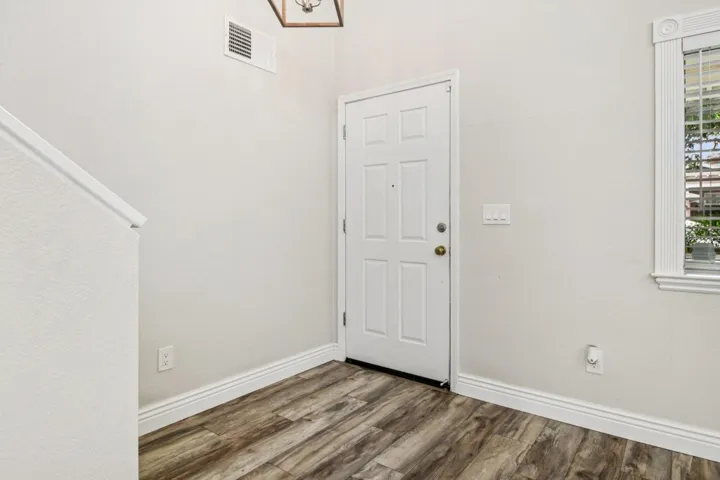 Entrance foyer with wood finished floors and baseboards