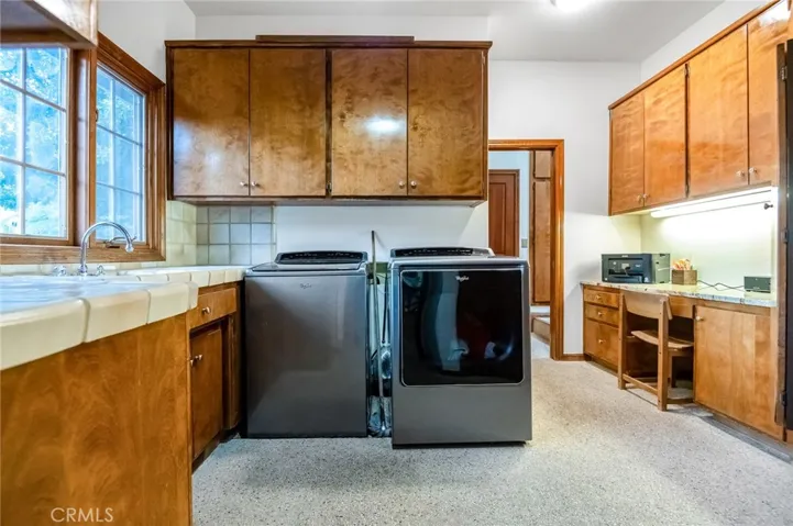 Utility room with built in desk, ironing board and chute