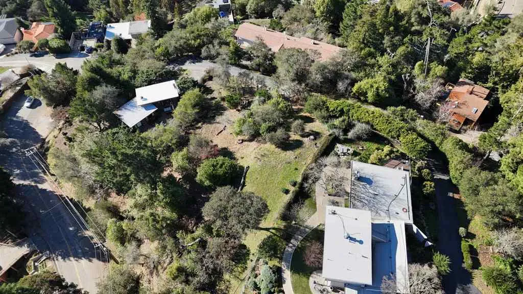 View of property location featuring a tree filled landscape