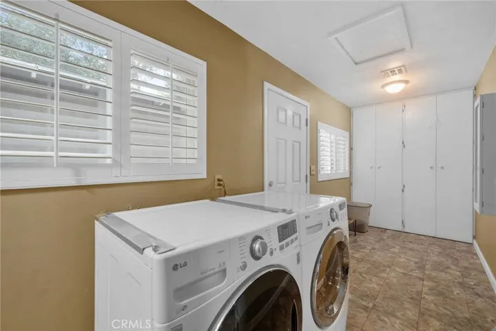 Spacious laundry, mud room and pantry area with access to the garage.