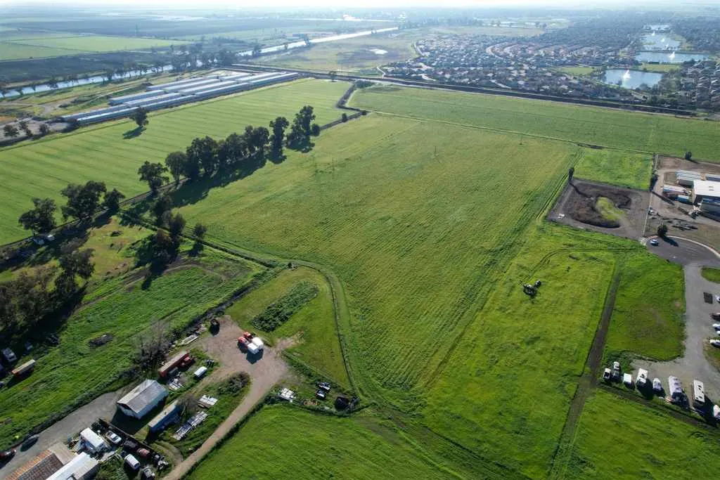 Aerial view of sparsely populated area with abundant farmland and a large body of water