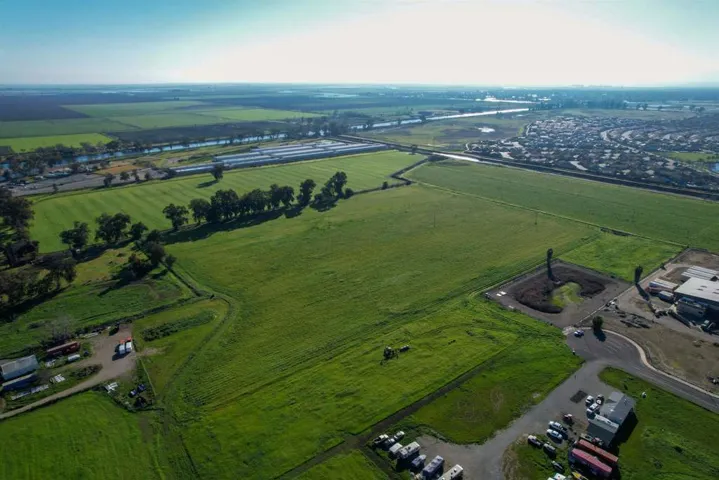 Aerial view of property's location featuring rural landscape and farmland