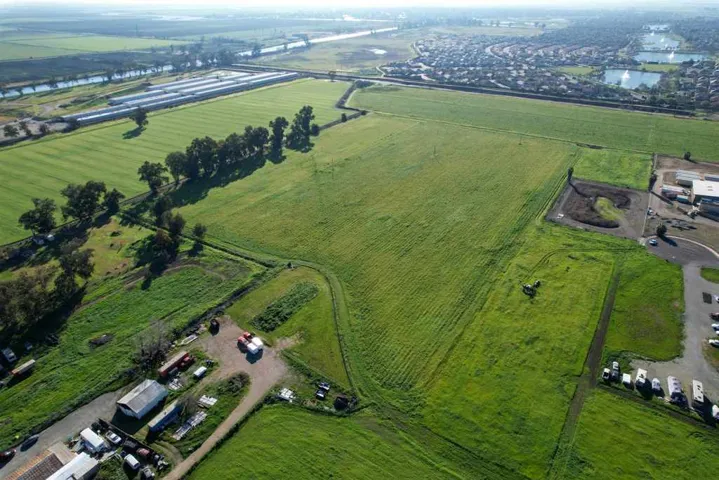 Aerial view of sparsely populated area with abundant farmland and a large body of water