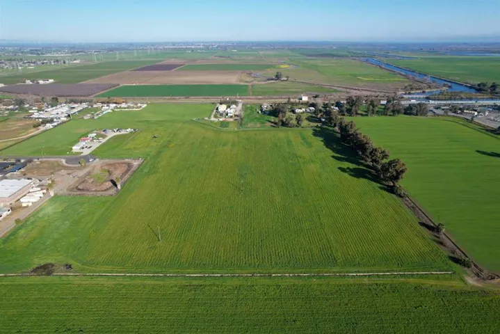 Aerial view of sparsely populated area featuring large plots for crops
