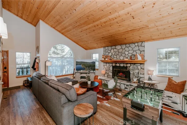 Vaulted wood-beamed ceilings and inviting fireplace