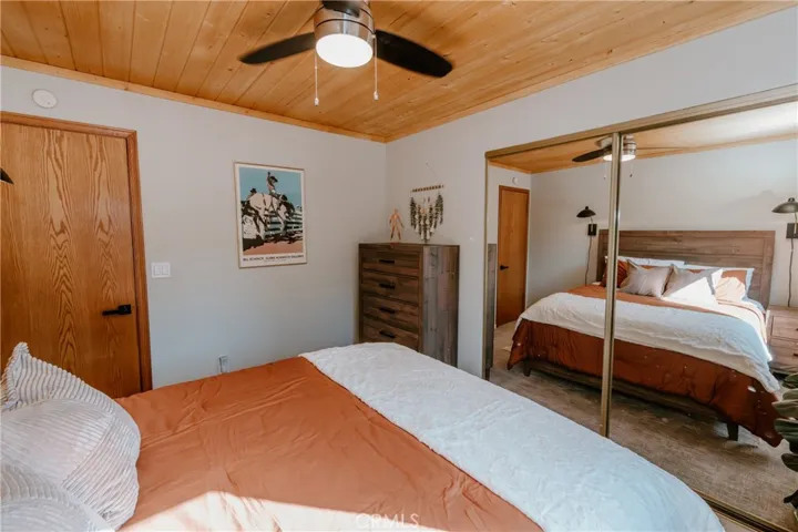 2nd Bedroom has a Queen bed, dresser and mirrored closet doors