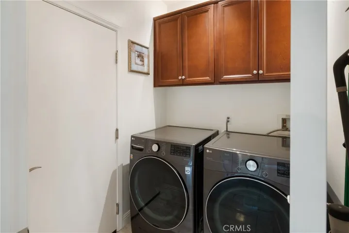 Laundry room with overhead storage