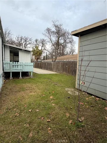 View from back Lefthand corner of property looking down side of house to enclosed porch.