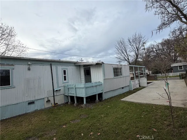 Side of house with entrance and enclosed porch.