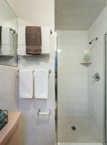 Full bathroom with a stall shower and toilet