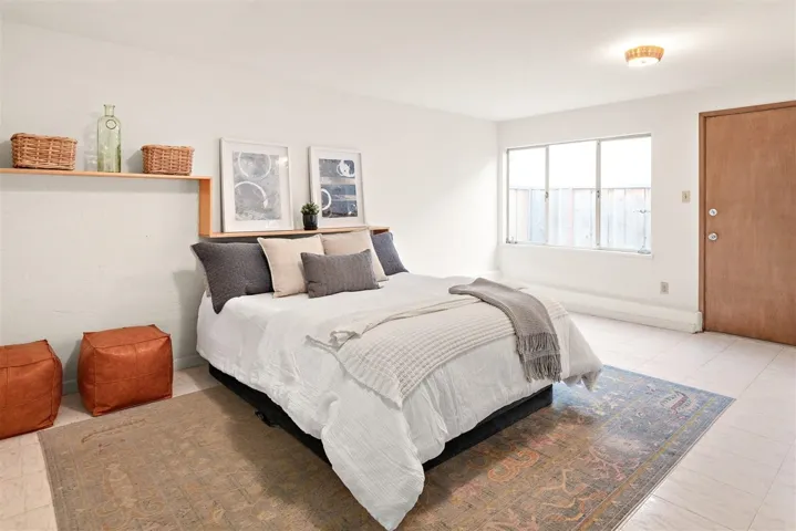 Bedroom with light tile patterned floors and baseboards