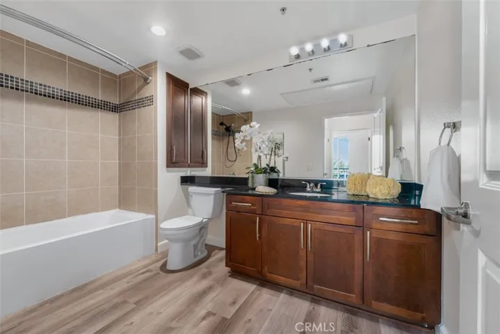 Hallway bathroom with shower over tub